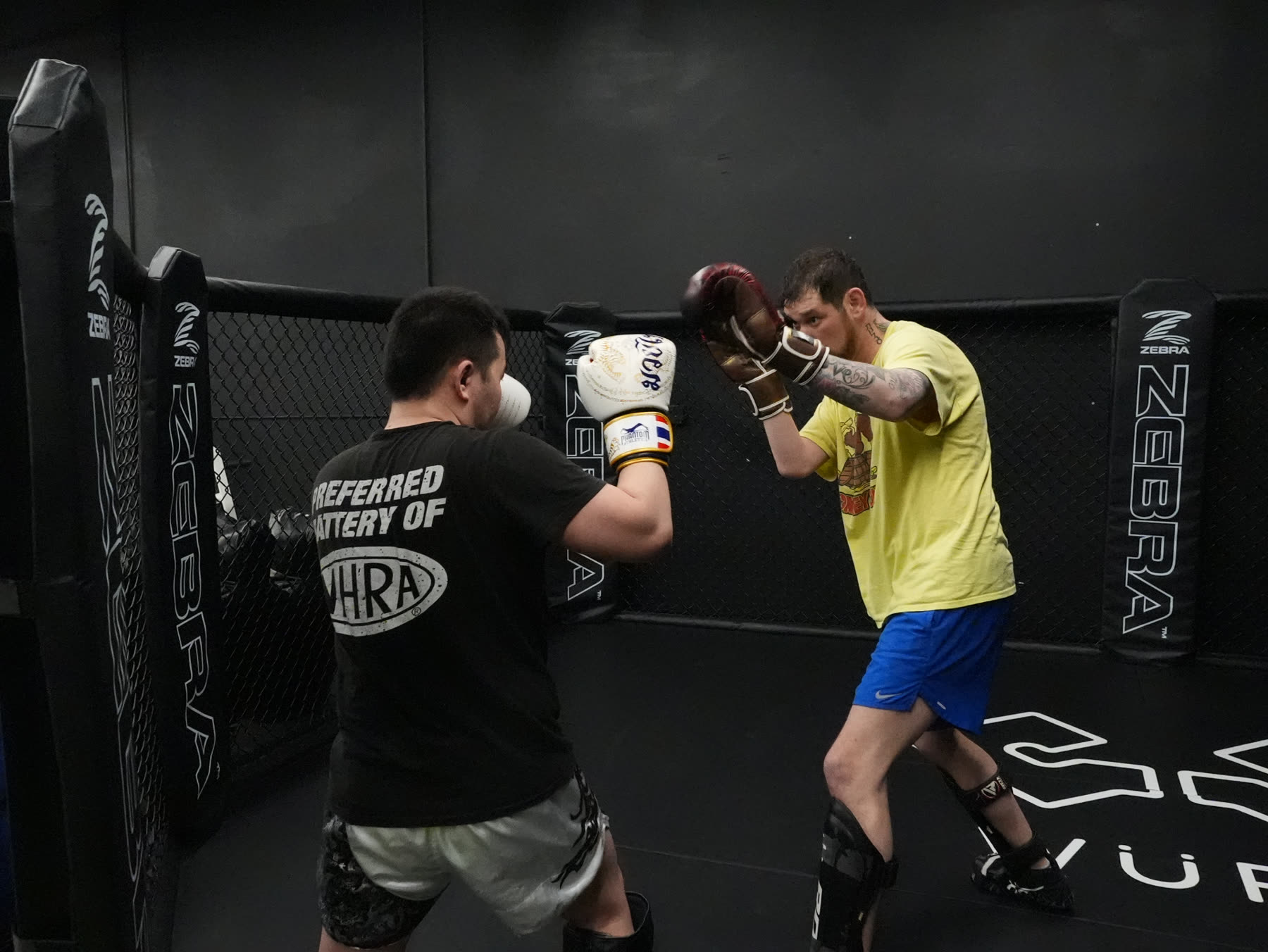 Cody Galloway training striking inside an MMA cage